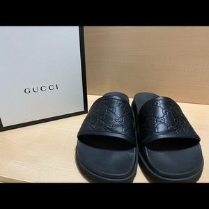 Men’s black Gucci slides